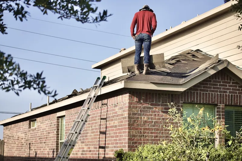 Professional roofer working on a residential roof in Sandy Point